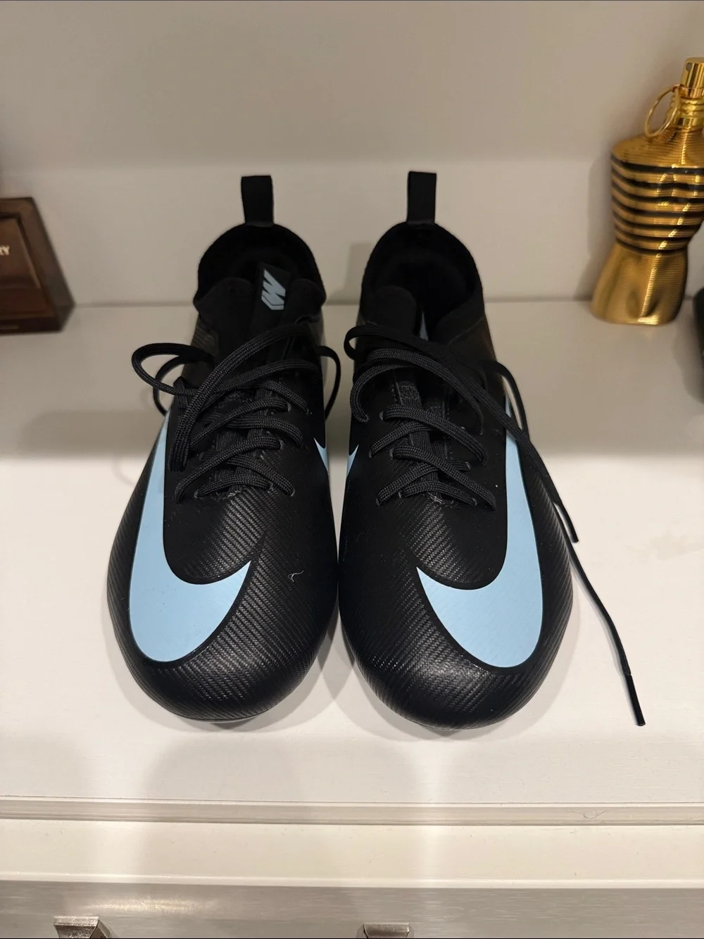 Nike Men’s Black Athletic Cleats with Light Blue Swoosh